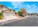 Inviting single-story house with a two-car garage, complemented by a charming, landscaped front yard at 3594 Wild Cherry Ct, Las Vegas, NV 89121