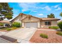 Well-kept home featuring a large driveway and a two-car garage, complimented by vibrant landscaping at 3594 Wild Cherry Ct, Las Vegas, NV 89121