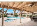 Relaxing backyard pool area with a covered patio and a separate hot tub for outdoor enjoyment at 3594 Wild Cherry Ct, Las Vegas, NV 89121