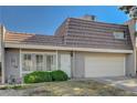 Charming townhome featuring a two-car garage, secure front door, and verdant landscaping, situated on a sunny day at 3642 Haverhill St, Las Vegas, NV 89121