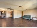 Spacious living room with updated flooring and ceiling fan at 403 Woodridge Dr, Henderson, NV 89015