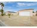 Single story home with two car garage, desert landscaping and a sunny blue sky at 434 Viewmont Dr, Henderson, NV 89015