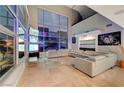 Spacious living room featuring tile floors, floor-to-ceiling windows, and a large sectional sofa at 4515 Dean Martin Dr # 200, Las Vegas, NV 89103