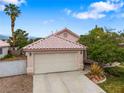 Single-story home showcasing a two-car garage, desert landscaping, and views at 4517 Rodman Dr, Las Vegas, NV 89130