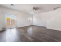Bright living room featuring sleek hardwood floors and a sliding glass door for natural light at 4608 Snake Eyes St # 102, Las Vegas, NV 89122
