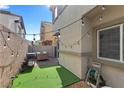 Cozy backyard features artificial grass, string lights, BBQ, and seating area, perfect for outdoor enjoyment at 4650 Ridgeley Ave # 103, North Las Vegas, NV 89084