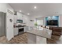 A modern, open-concept kitchen featuring granite countertops and stainless steel appliances at 4650 Ridgeley Ave # 103, North Las Vegas, NV 89084