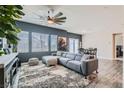 Stylish living room with comfortable seating, modern ceiling fan and multiple windows at 4720 Flower Moon Ave # 101, North Las Vegas, NV 89084