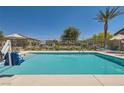 Community pool and recreation area, including shaded tables and lounge chairs at 4720 Flower Moon Ave # 101, North Las Vegas, NV 89084
