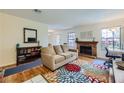 Bright and spacious living room featuring a fireplace, couch, and colorful rug at 5576 W Rochelle Ave # 27C, Las Vegas, NV 89103