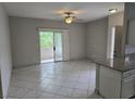 Open living room with sliding glass door to balcony and tile flooring at 5655 E Sahara Ave # 2020, Las Vegas, NV 89142