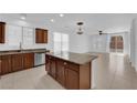 Open-concept kitchen featuring stainless steel appliances, a large island, and bright living space at 5960 Addy Ln, North Las Vegas, NV 89081