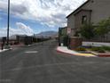 Community gated entrance with lush landscaping at 6450 Spring Jog St, Las Vegas, NV 89166