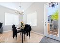 Cozy dining area with natural light and access to outdoor balcony at 7047 Sombra Way, Las Vegas, NV 89113
