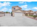 Inviting home with a large driveway and beautiful exterior features for a comfortable and stylish living experience at 720 Picasso Picture Ct, North Las Vegas, NV 89081