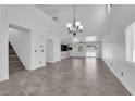 Spacious living room with high ceilings, tiled floors, modern lighting, and an open layout for versatile living at 720 Picasso Picture Ct, North Las Vegas, NV 89081