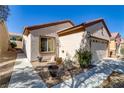 Attractive single-story home with desert landscaping, and a convenient two-car garage at 7669 Fieldfare Dr, North Las Vegas, NV 89084