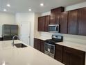 Bright kitchen with stainless steel appliances and island at 7672 Lush Oasis Ave, Las Vegas, NV 89113