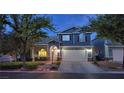 Charming two-story home featuring a two-car garage, well-manicured landscaping, and a welcoming covered front porch at 7728 Whispering River St, Las Vegas, NV 89131