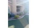 Cozy backyard featuring artificial turf, a small patio, and privacy landscaping at 8805 Jeffreys St # 1112, Las Vegas, NV 89123
