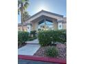 Attractive community clubhouse featuring a stone walkway and lush landscaping at 8805 Jeffreys St # 1112, Las Vegas, NV 89123