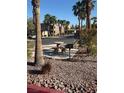 Outdoor picnic area in community featuring a charcoal grill and mature landscaping at 8805 Jeffreys St # 1112, Las Vegas, NV 89123