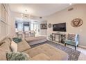 Comfortable living area featuring a large sectional sofa and open flow to the kitchen at 91 E Agate Ave # 204, Las Vegas, NV 89123