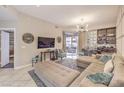 Inviting living room with a plush sectional sofa, TV, and sliding door to outdoor area at 91 E Agate Ave # 204, Las Vegas, NV 89123