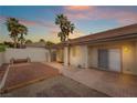 Serene backyard featuring a covered patio and brick pavers with desert landscaping and bench at 9289 Mandeville Bay Ave, Las Vegas, NV 89148