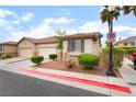 Charming single-story home with a well-maintained front yard and a two-car garage and palm trees at 9289 Mandeville Bay Ave, Las Vegas, NV 89148
