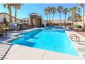 Resort-style community pool with comfortable lounge chairs and meticulously maintained landscaping provides a relaxing outdoor oasis at 9289 Mandeville Bay Ave, Las Vegas, NV 89148