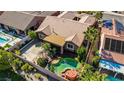 An aerial view showcasing the property's layout, pool, landscaping, and proximity to neighboring homes at 936 Viscanio Pl, Las Vegas, NV 89138
