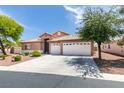 Charming single-story home with a three-car garage and low maintenance desert landscaping at 9524 Tyler Rose St, Las Vegas, NV 89178