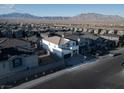 Expansive aerial view of a modern home in a planned community with stunning mountain views at 10204 Kern Peak St, Las Vegas, NV 89166