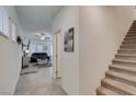 Inviting entryway with tile flooring, stairs, and living room views showcasing the open floorplan at 10939 Cheshire Woods Ave, Las Vegas, NV 89166