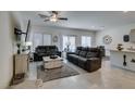 Open-concept living room featuring neutral tones, tile flooring, and abundant natural light at 10939 Cheshire Woods Ave, Las Vegas, NV 89166