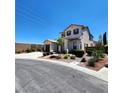 Two-story residence featuring a two-car garage, complemented by meticulous landscaping and mature trees at 11201 Newbury Hills Ave, Las Vegas, NV 89138