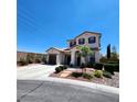 Inviting two-story house showcasing a dual-car garage, stone walkway, and neatly arranged landscaping at 11201 Newbury Hills Ave, Las Vegas, NV 89138