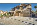Attractive two-story home with a tiled roof, desert landscaping, and a spacious three-car garage with extended driveway at 1191 Starstone Ct, Henderson, NV 89014