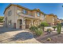 Two-story home with a landscaped yard, covered entry, and welcoming curb appeal at 1191 Starstone Ct, Henderson, NV 89014