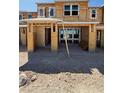New home construction showing exposed wood framing, windows, and covered parking area in the community at 128 Silver Run Ln, Las Vegas, NV 89138