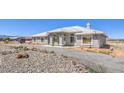Desirable single-level home showcasing a classic design, xeriscaped landscaping, and a lengthy driveway for easy access at 1410 Tiptop Trl, Pahrump, NV 89048