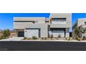 Modern two-story home with sleek architectural details, desert landscaping and a three car garage at 1548 Pleasant Bay Ct, Henderson, NV 89011