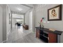 Spacious foyer with tile flooring, art display, and an open view to the living area at 16 Via Stefano, Henderson, NV 89011