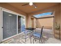 Cozy covered patio with ceiling fan, table and chairs, perfect for outdoor dining at 16 Via Stefano, Henderson, NV 89011