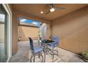 Inviting covered patio featuring a ceiling fan and a stylish outdoor dining set at 16 Via Stefano, Henderson, NV 89011