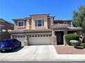 Charming two-story home with a three-car garage and desert landscaping at 2112 Merganser Ct, North Las Vegas, NV 89084