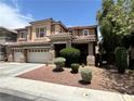 Two-story home features mature trees, desert landscaping, and three-car garage at 2112 Merganser Ct, North Las Vegas, NV 89084