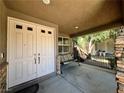 Inviting front porch with a comfortable swing, perfect for relaxing outdoors at 2112 Merganser Ct, North Las Vegas, NV 89084
