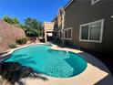 Sparkling backyard pool surrounded by lush landscaping, ideal for summer fun at 2112 Merganser Ct, North Las Vegas, NV 89084